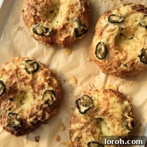 A savory 3-ingredient bagel, topped with melted cheese and spicy jalapeños, resting on a baking tray.