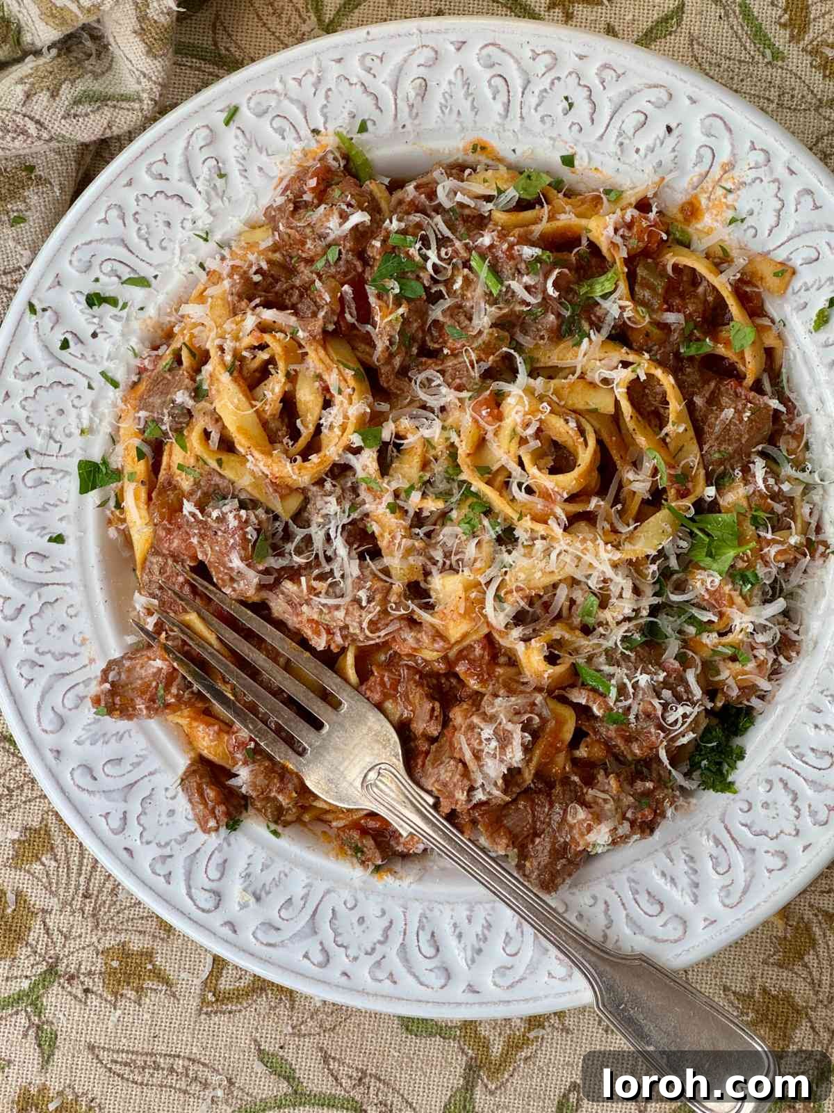 Meltingly Tender Beef Shin Ragu 2 beef shin ragu with tagliatelle in a white bowl.