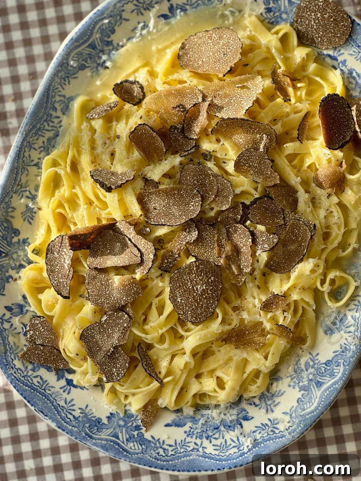 Silky Truffle Pasta Delight 2 truffles with pasta on a plate.