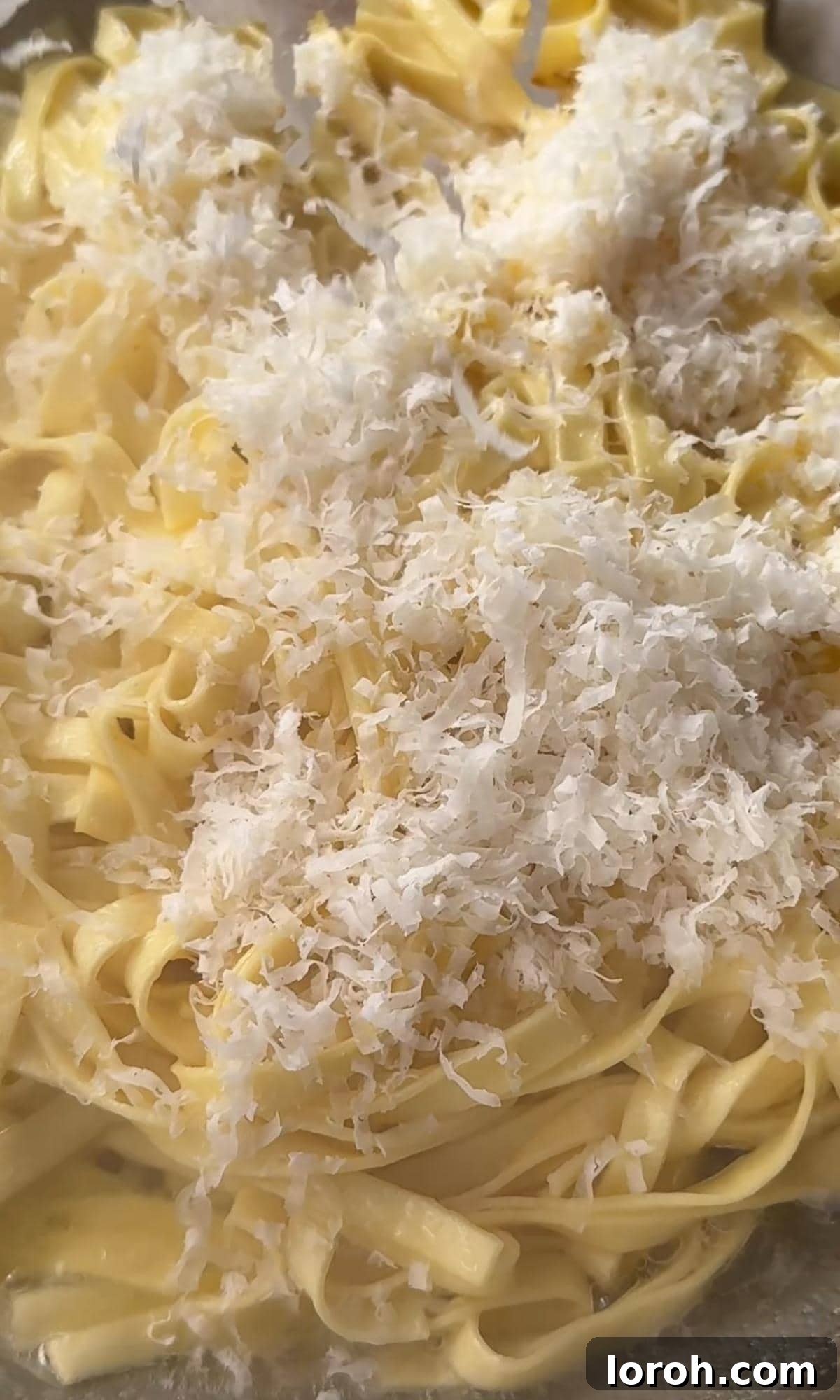 Silky Truffle Pasta Delight 4 adding parmesan to pasta.