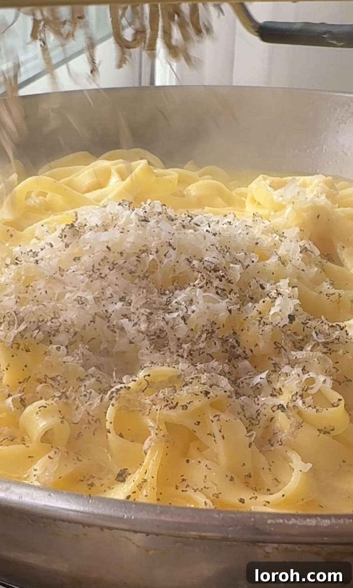 Silky Truffle Pasta Delight 5 grating truffle into pasta.