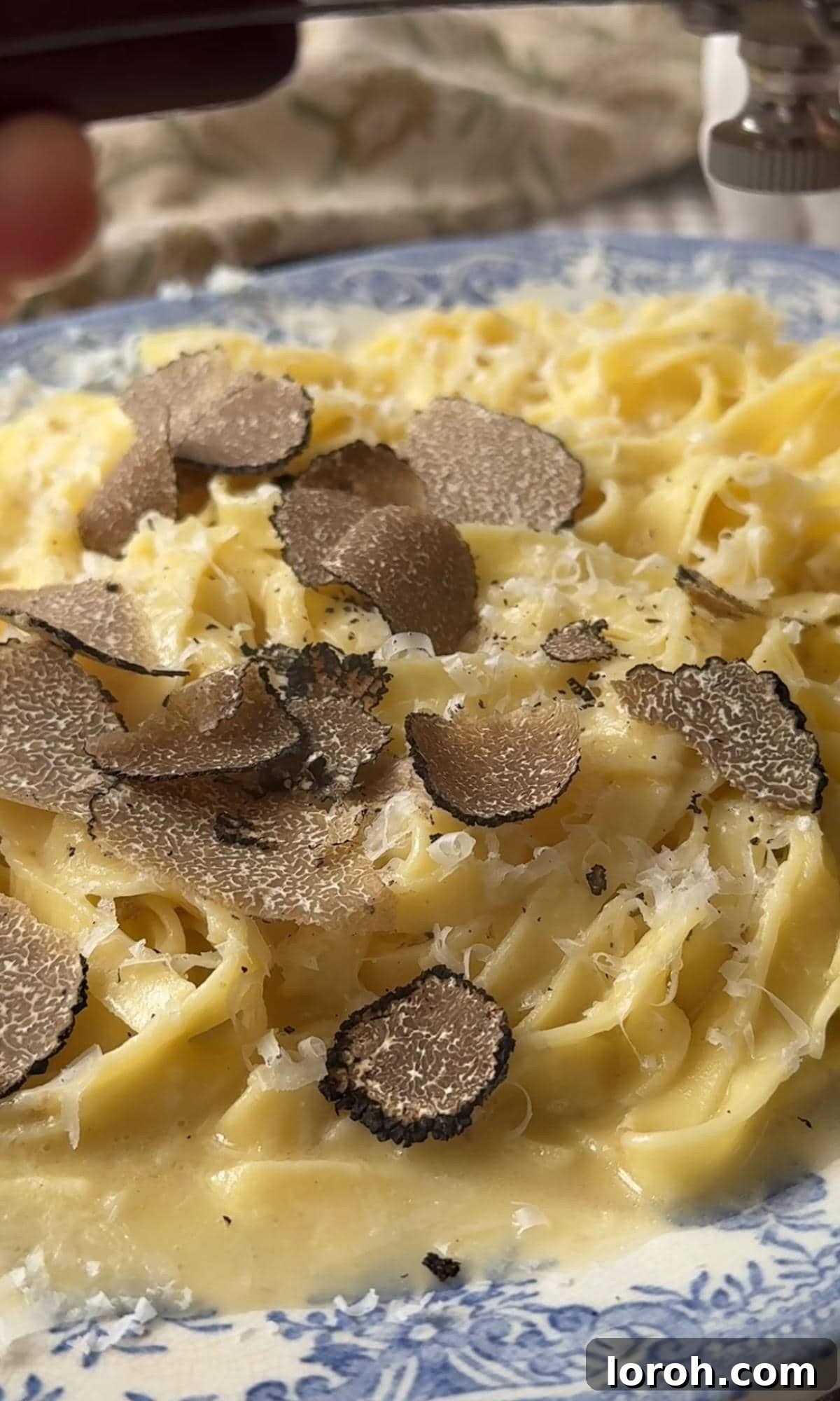 Silky Truffle Pasta Delight 6 shaving truffles into pasta.