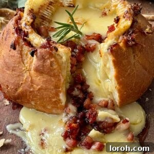 Oven Roasted Camembert (Camembert Rôti) in a bread bowl with crispy pancetta.