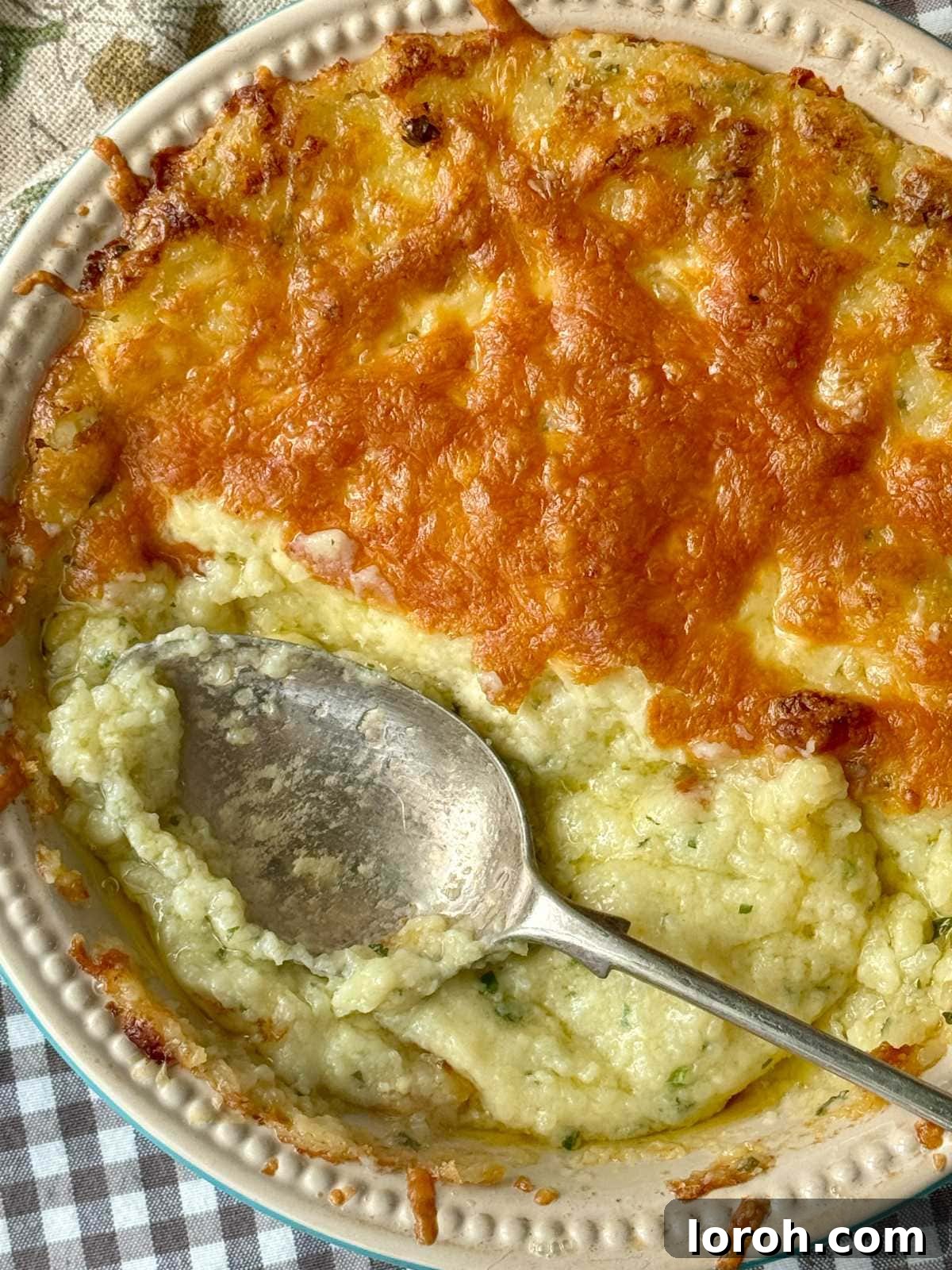 Decadent Twice Baked Mashed Potatoes 3 twice baked mashed potatoes in a dish with cheese on top.