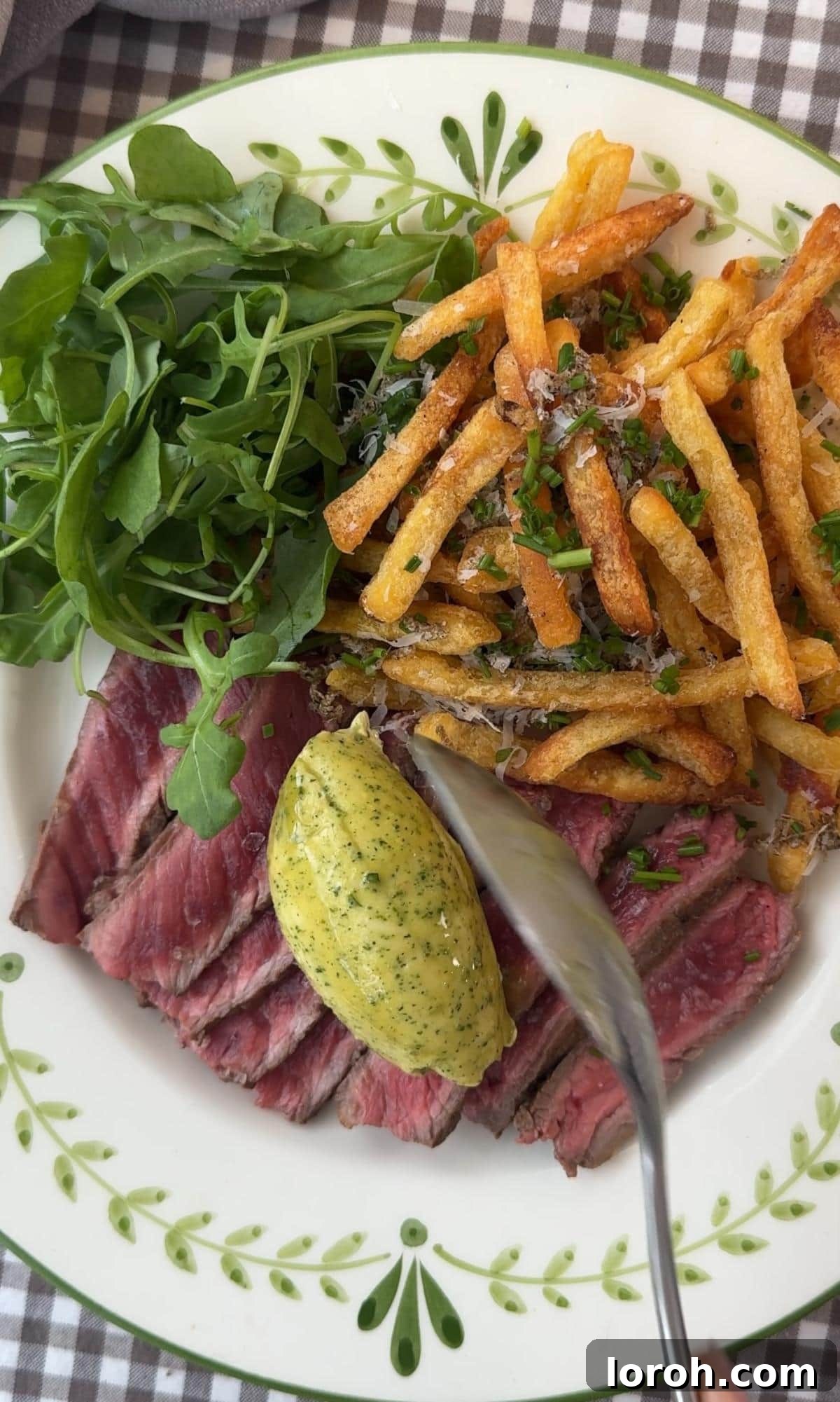 Effortless Homemade Cafe de Paris Butter 7 Serving freshly made Cafe de Paris butter on a juicy steak, showcasing its melting quality.