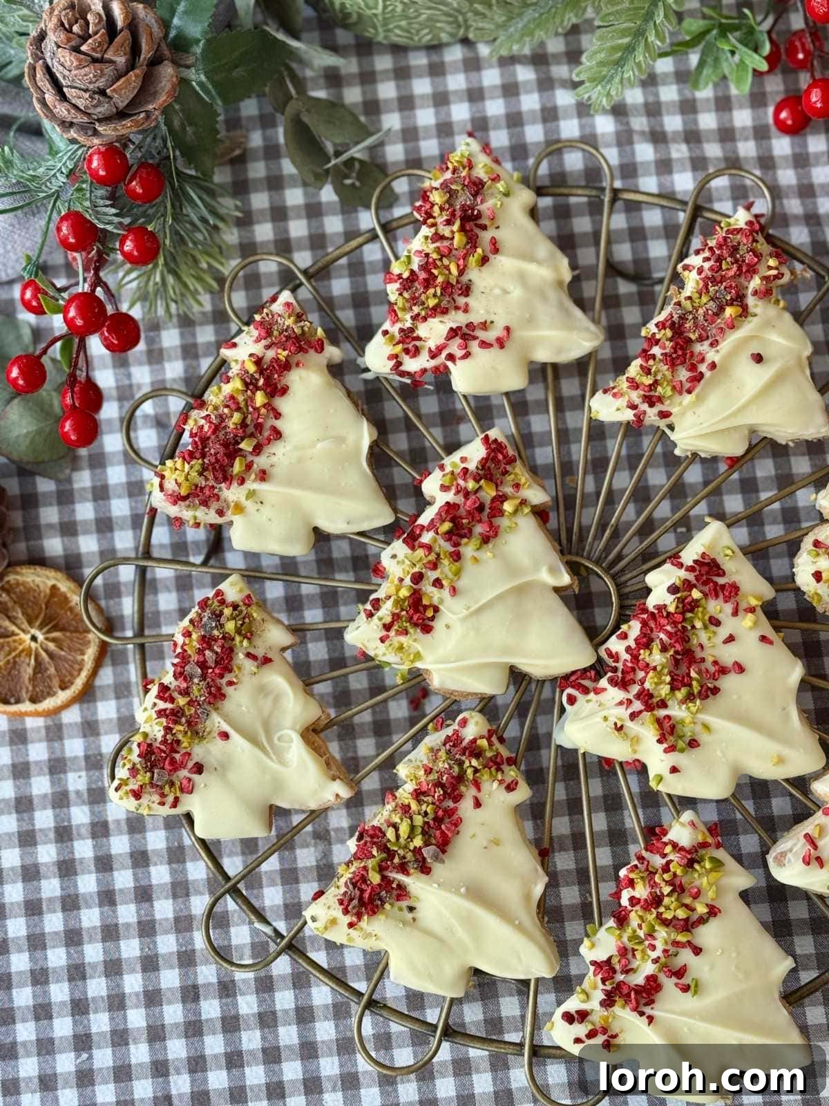 christmas tree cookies on a baking tray, beautifully decorated.