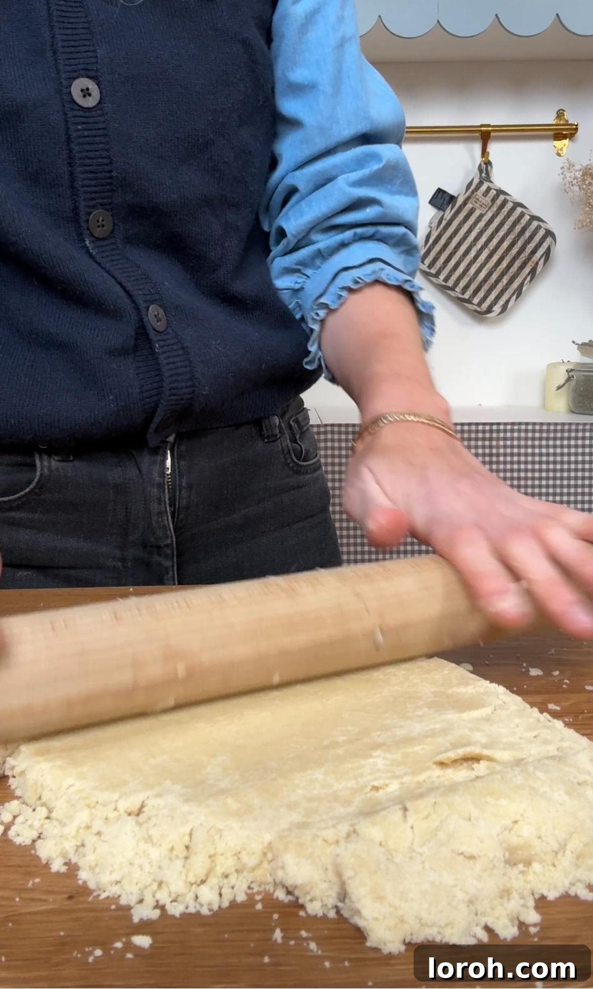 rolling the cookie dough into a sheet on a floured surface.