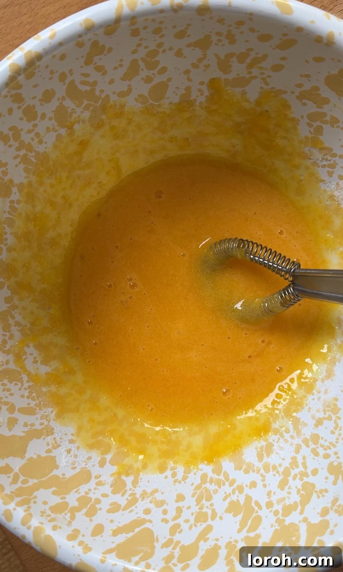 Velvet Chocolate Budino 4 Whisking egg yolks and caster sugar together in a large mixing bowl until the mixture becomes pale and creamy.