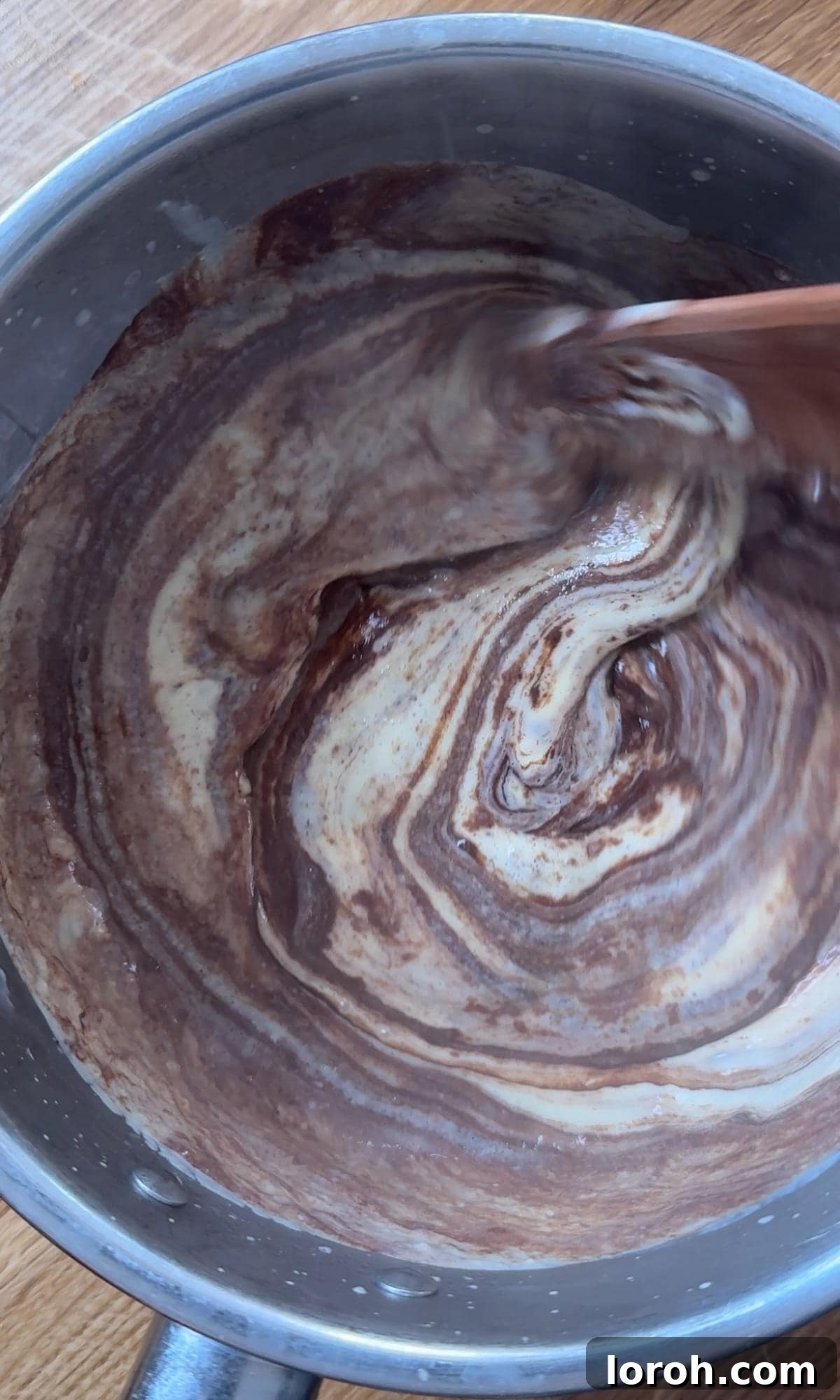 Velvet Chocolate Budino 7 Adding chopped dark chocolate to the warm custard, allowing it to melt into a smooth, glossy mixture.