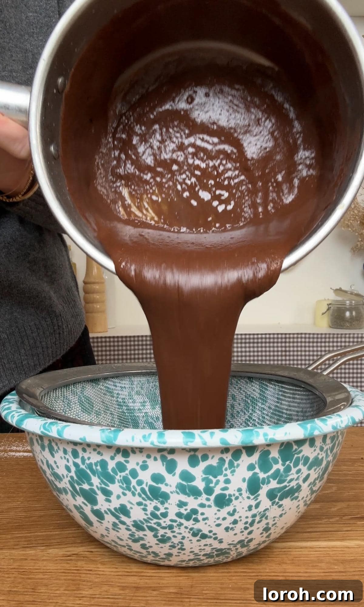 Velvet Chocolate Budino 8 Straining the finished budino mixture through a fine-mesh sieve to ensure a perfectly smooth and lump-free texture.