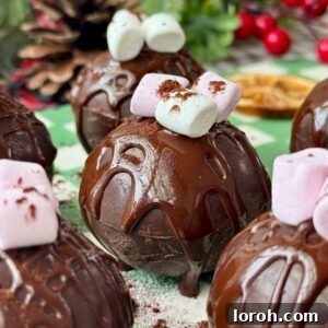 hot chocolate bomb on a plate with marshmallows on top.