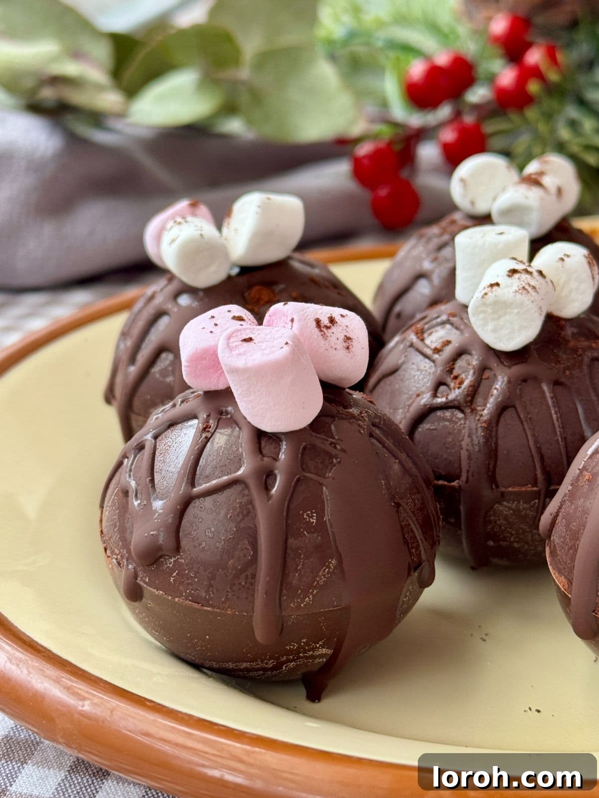 Two assembled hot chocolate bombs ready to be used.