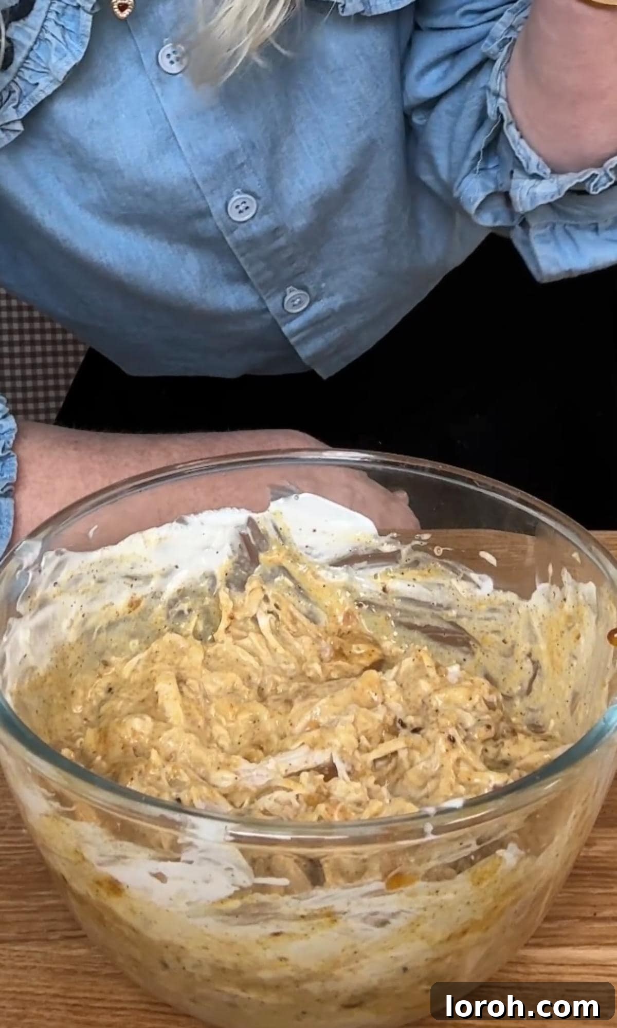 The Ultimate Coronation Chicken Sandwiches 6 Thoroughly mixing the coronation chicken filling until evenly coated.