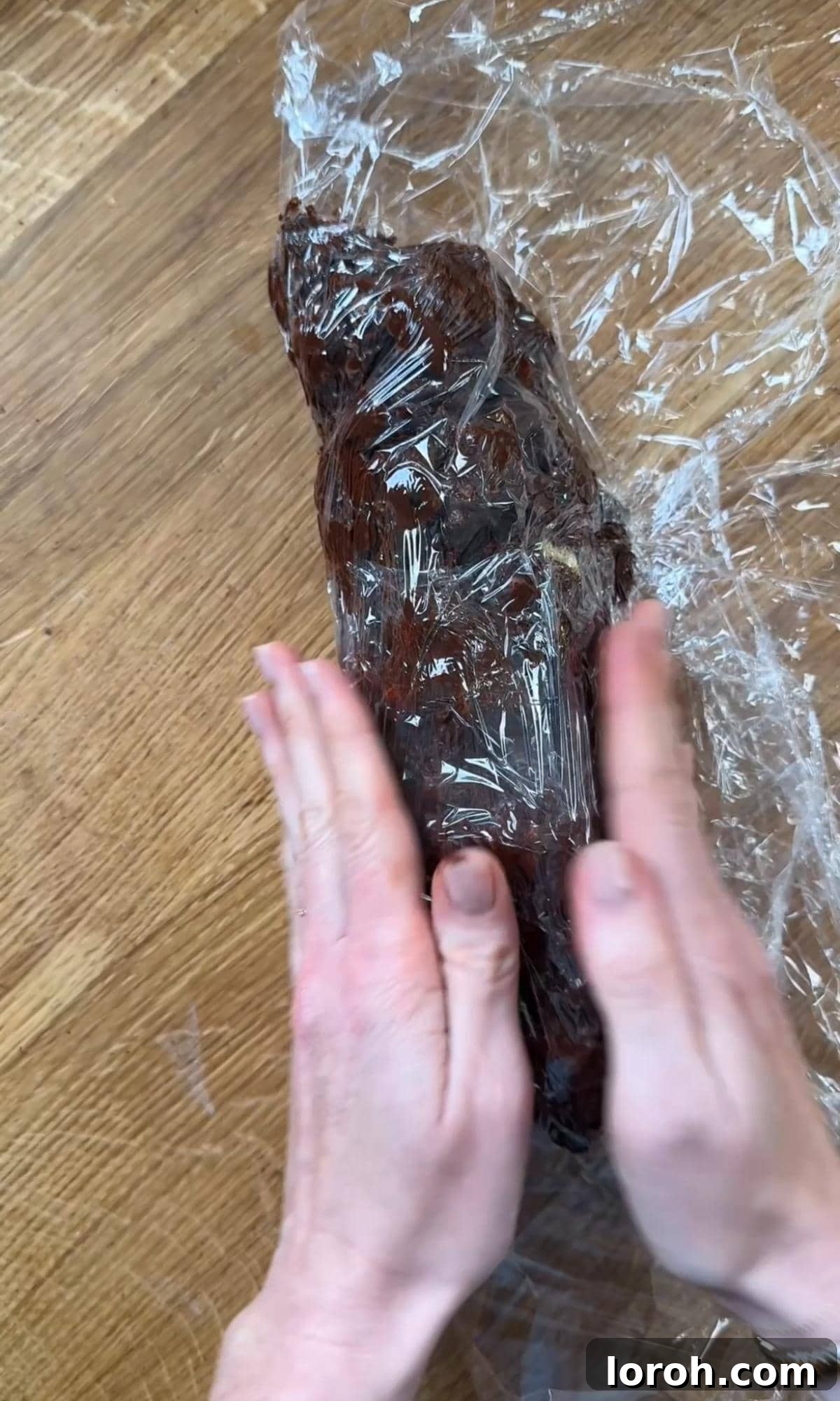 Decadent Chocolate Salami 7 wrapping and shaping chocolate salami in cling film.