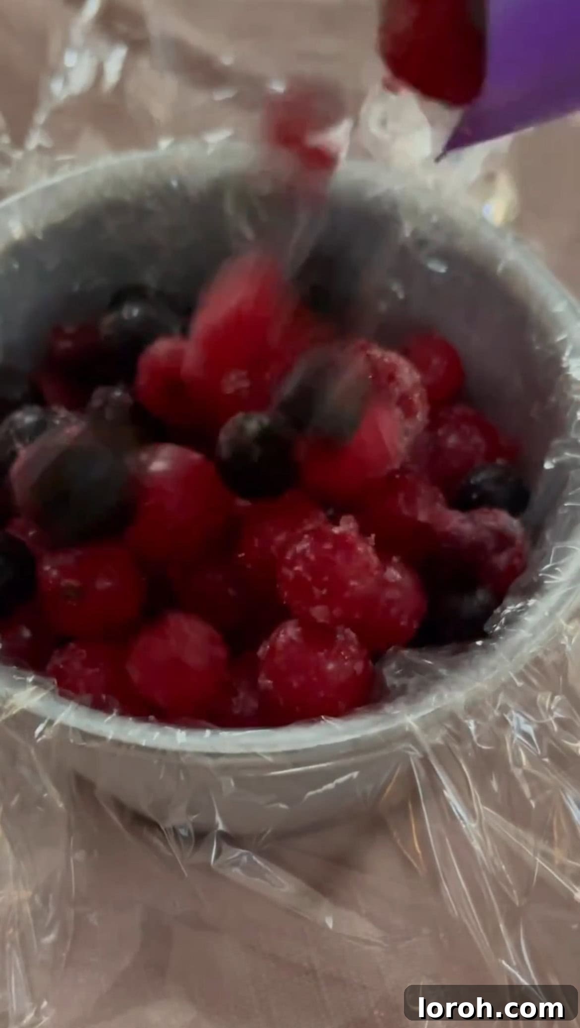 Warm White Chocolate Berry Indulgence 3 Preparing the frozen berries in a ramekin lined with clingfilm, ready for freezing.