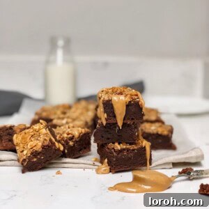 Tom Kerridge's fudgy peanut butter brownies with a swirl of creamy peanut butter on top, served on a light background