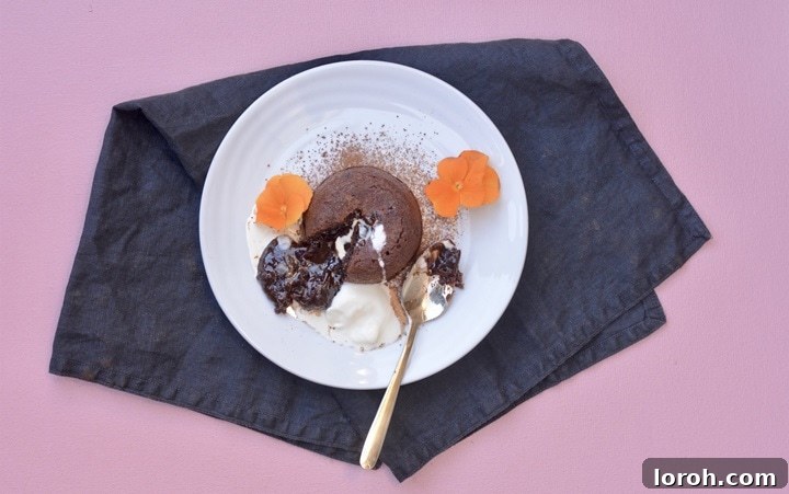 Ben Ebbrell Co-founder and Culinary Visionary at SORTED food Episode 32 2 A beautifully presented Melt in the Middle Chocolate Pudding with a molten chocolate center, garnished with berries.