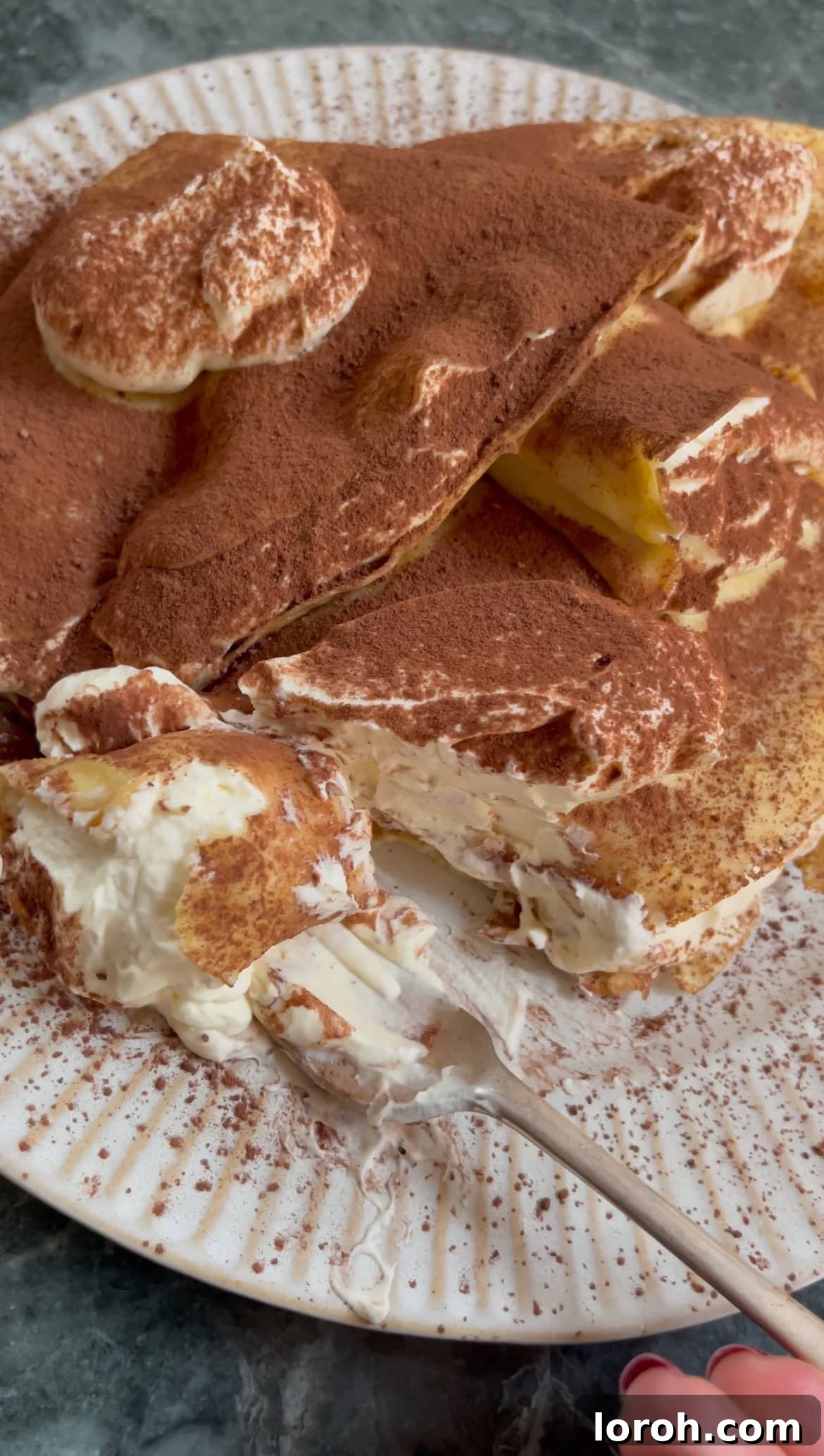 tiramisu pancakes with a fork, showing the creamy filling.