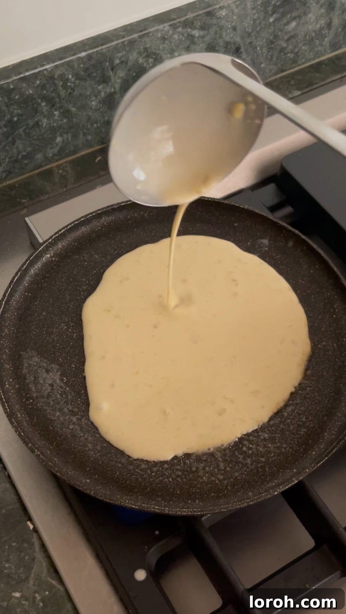 frying a thin pancake in a pan.