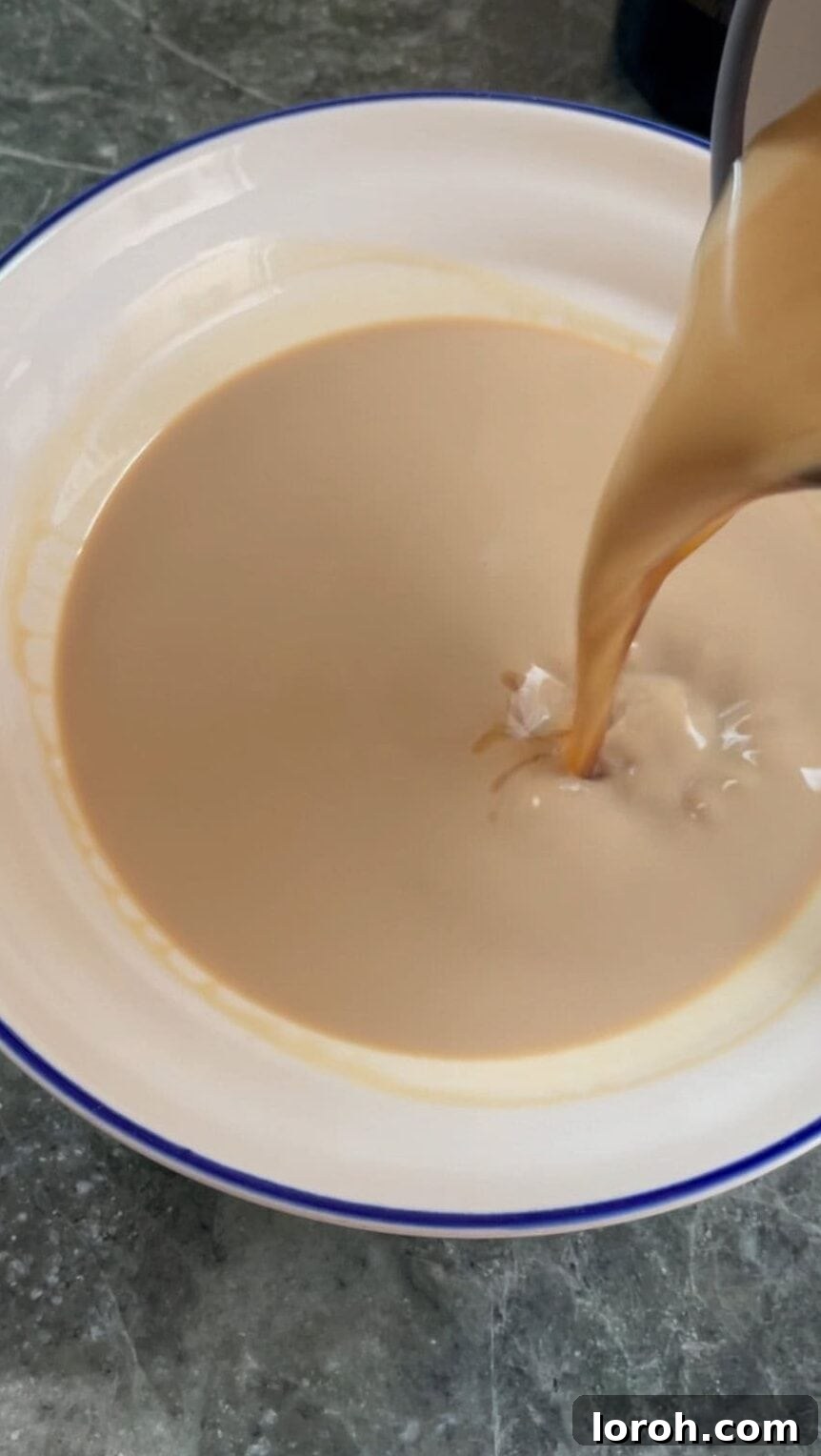 mixing coffee and Baileys in a shallow dish.