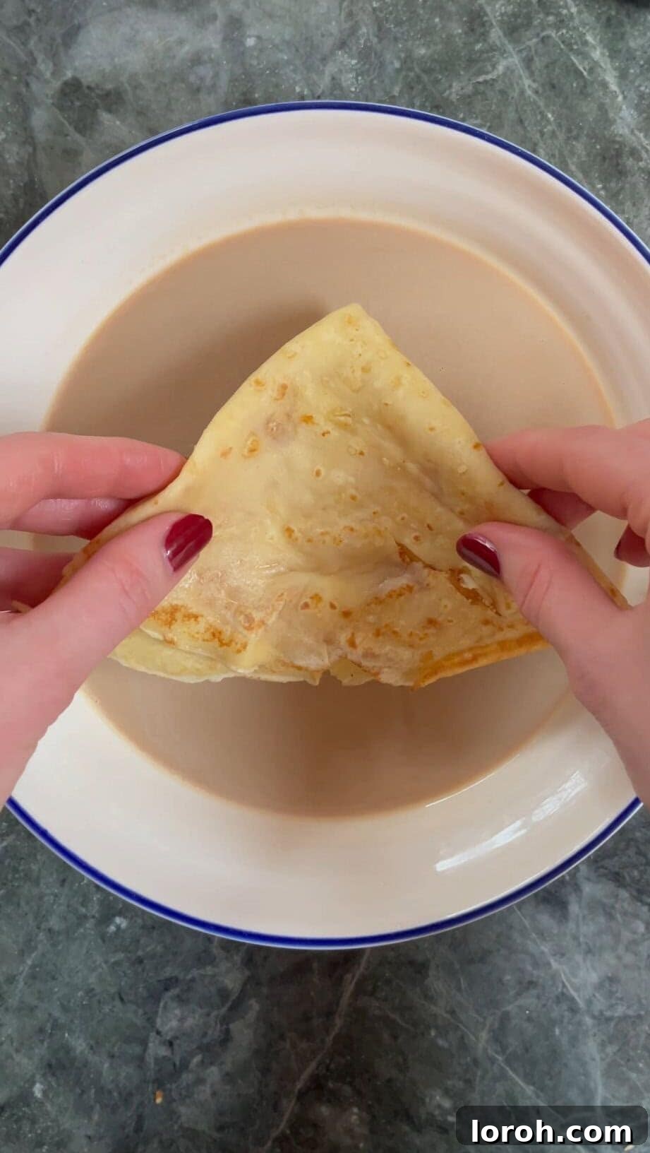 dipping a pancake into the coffee Baileys soak.