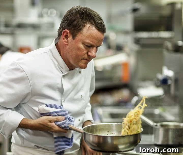 Theo Randall smiling warmly in his restaurant kitchen