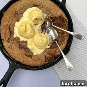 Irresistible brown butter chocolate chip skillet cookie served warm with ice cream
