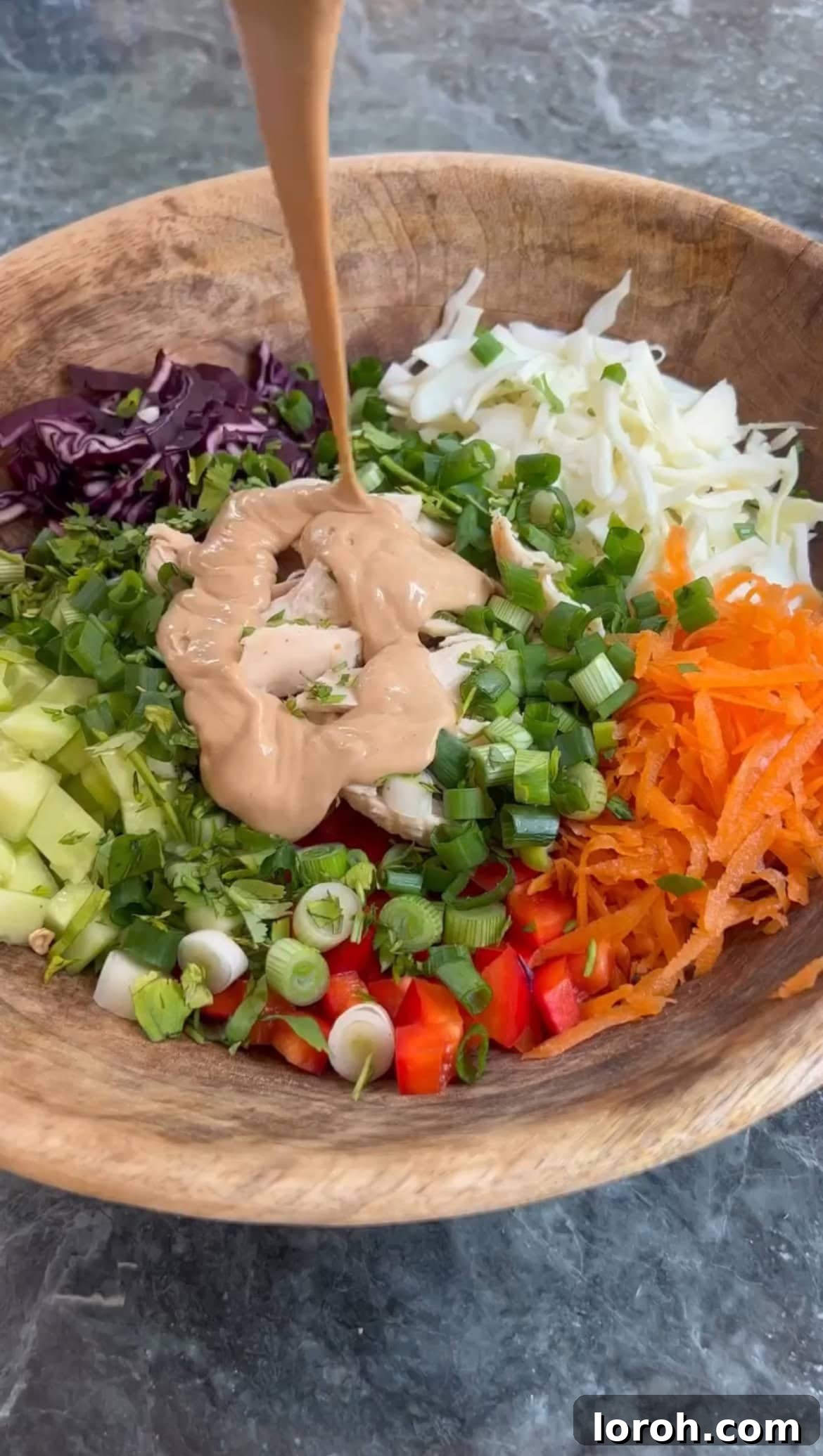Vibrant Thai Peanut Chicken Salad 5 Thai Peanut Dressing being drizzled over the salad