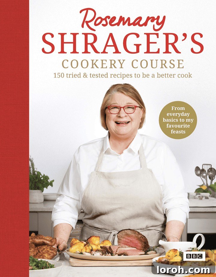 Rosemary Shrager smiling warmly, holding a culinary creation in a professional kitchen setting.