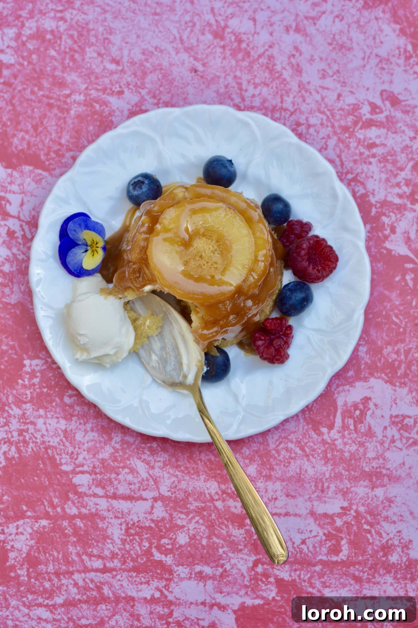 A close-up of a delightful mini pineapple upside down cake, showcasing its moist texture and golden caramel top.