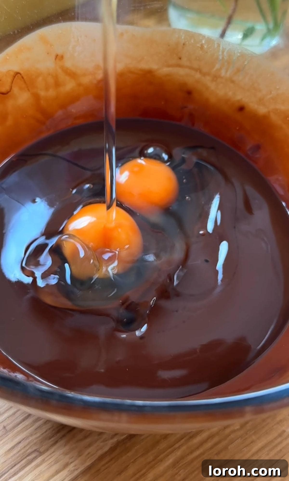 Molten Lava Chocolate Pudding 6 Adding eggs to the melted chocolate and butter mixture for melt-in-the-middle puddings.