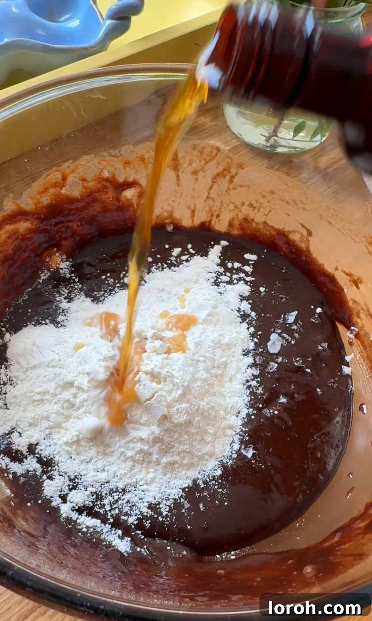 Molten Lava Chocolate Pudding 8 Adding vanilla extract, coffee powder, and salt to the chocolate pudding mixture.
