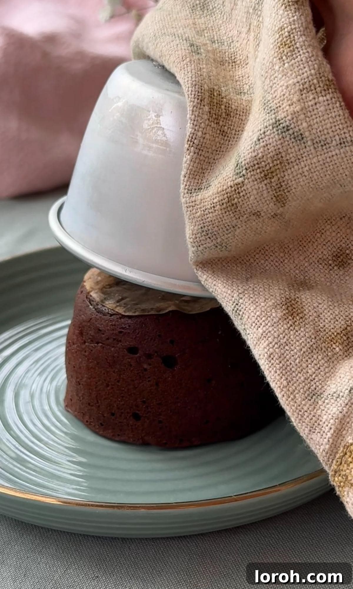 Molten Lava Chocolate Pudding 10 Inverting a freshly baked melt-in-the-middle chocolate pudding onto a plate.