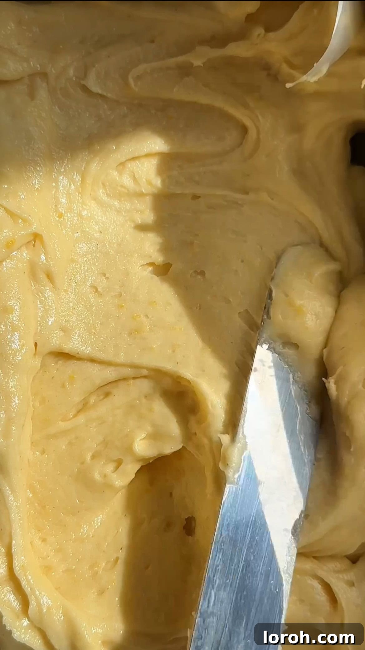 Sunshine Lemon Loaf 9 Cake batter being smoothed into a prepared loaf tin before baking.