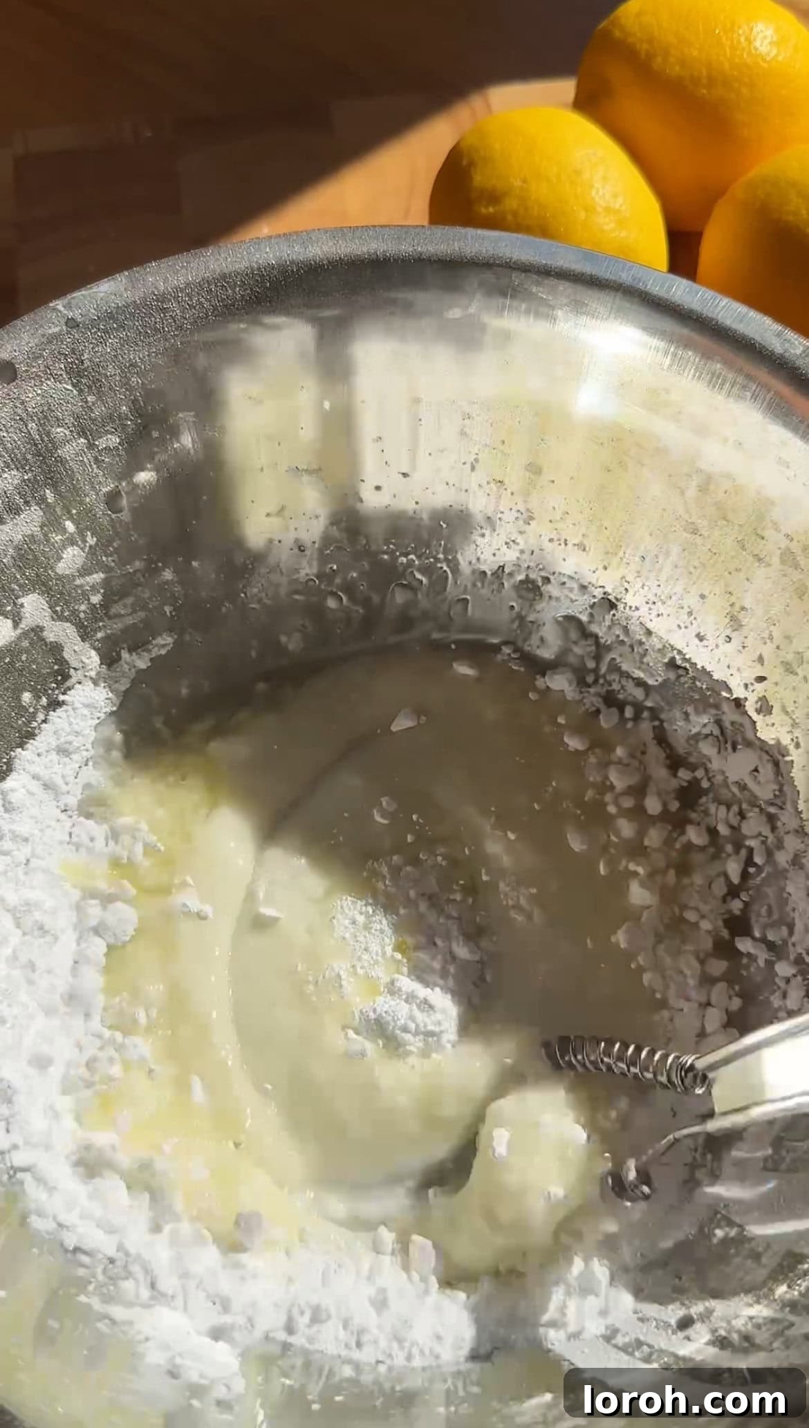 Sunshine Lemon Loaf 10 Icing sugar being sieved into a bowl, ready to be mixed with lemon juice for the drizzle.