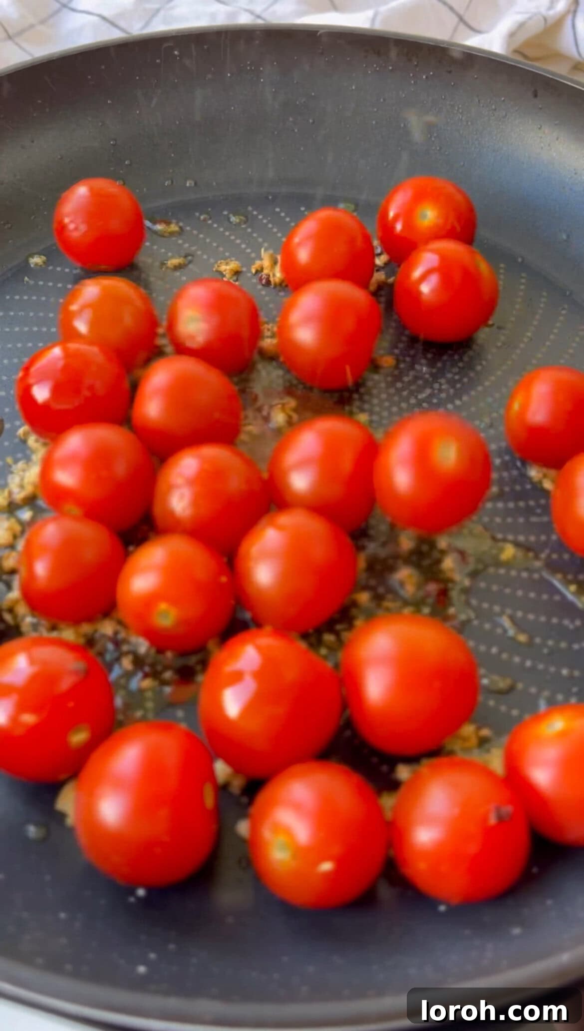 Bursting Burrata Tomato Pasta 4 Adding cherry tomatoes to the pan with garlic and chili for Burrata Pasta.