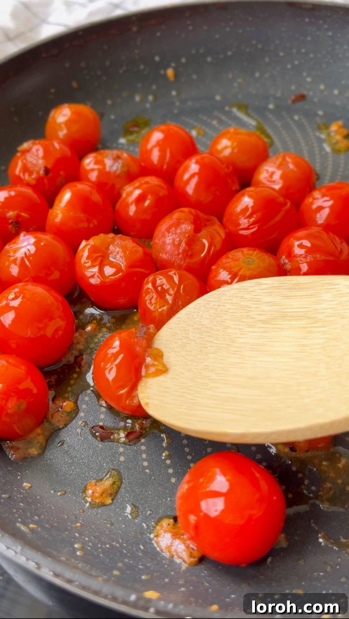 Bursting Burrata Tomato Pasta 5 Squashing bursting cherry tomatoes in the pan to create a sauce for Burrata Pasta.