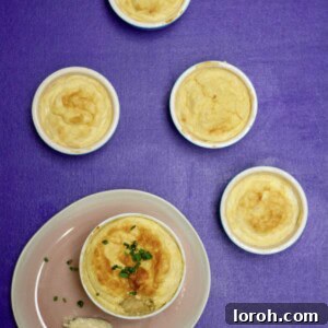 Golden brown cheese soufflé perfectly risen in a round dish