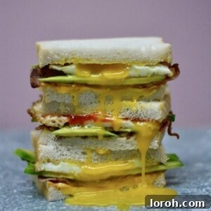 Delicious Bacon, Egg & Avocado Sandwich with runny yolk