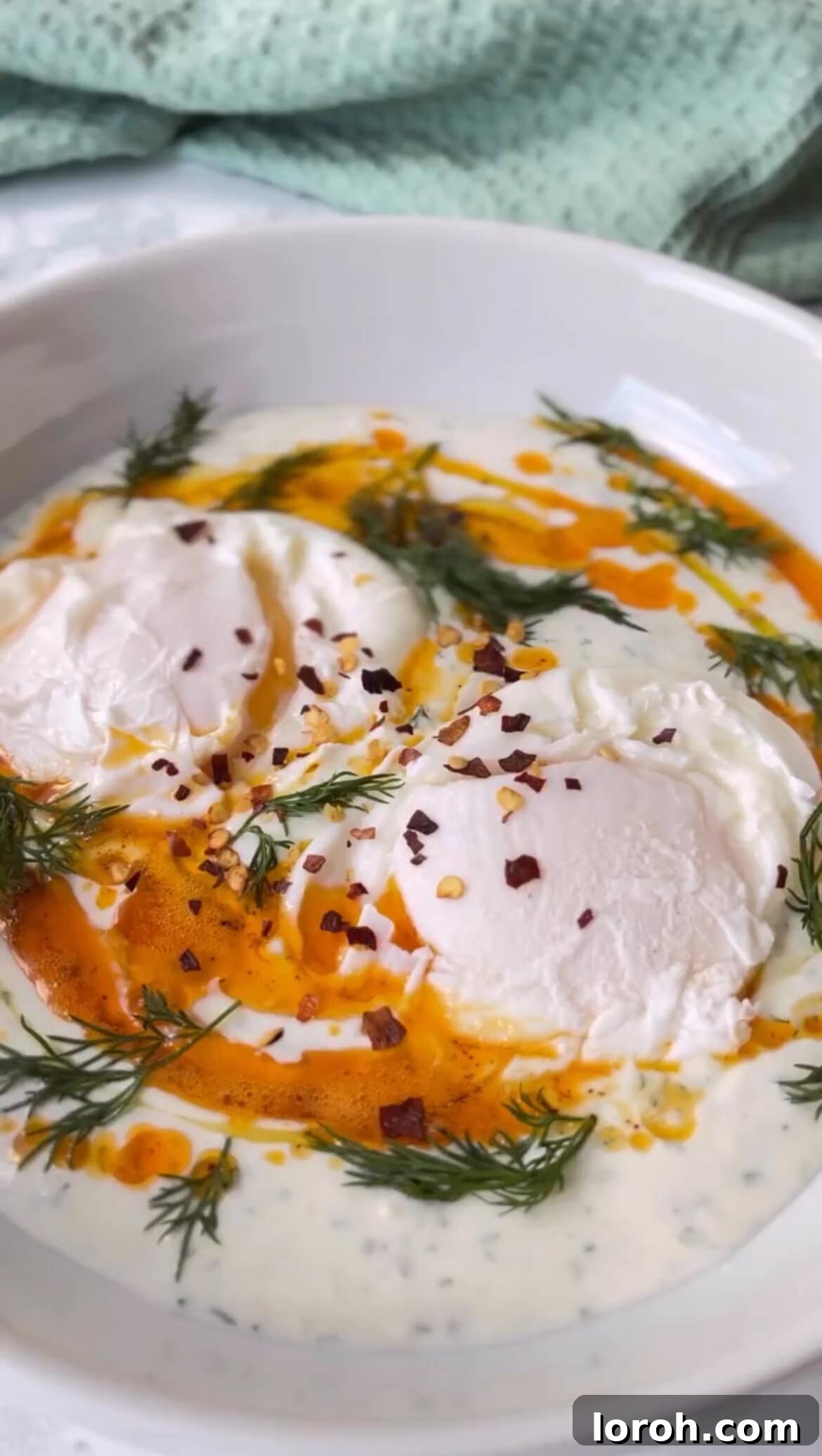 Final assembly and plating of Turkish Eggs, drizzling butter and adding eggs to yogurt