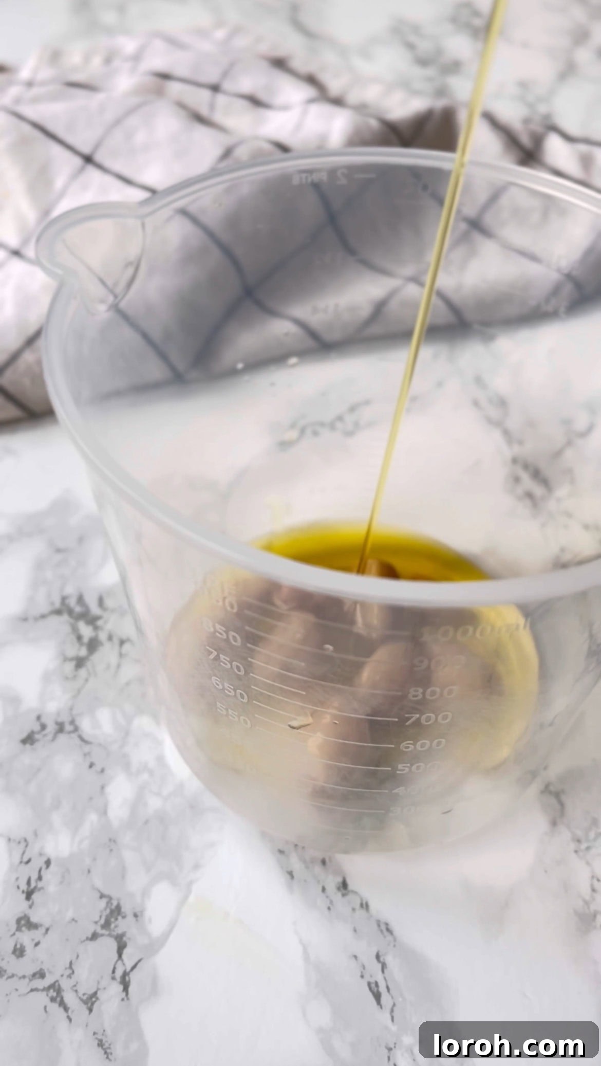 adding confit garlic and oil to make roasted garlic aioli