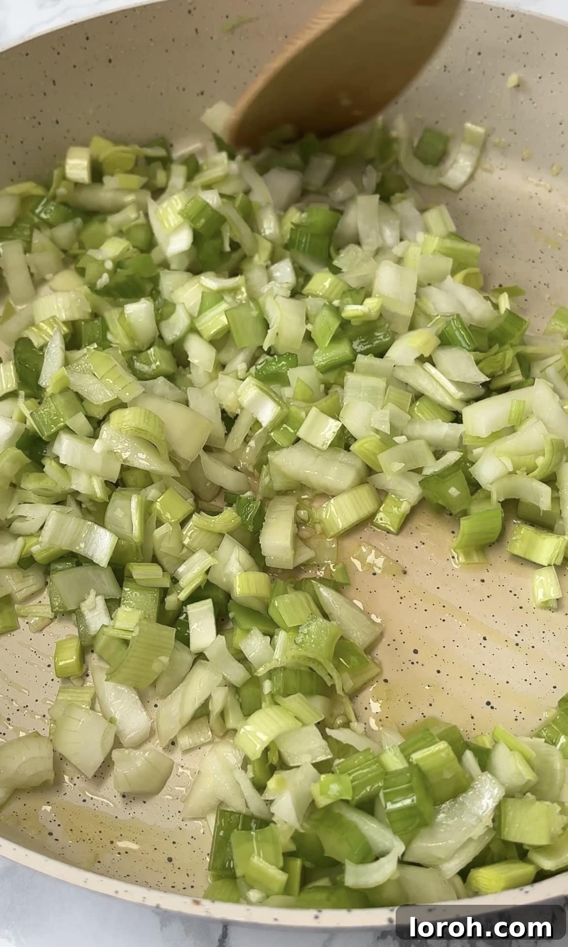 Fiery Harissa Chicken and Speedy Couscous 7 Diced onions, leek, and celery frying in olive oil in a separate pan.