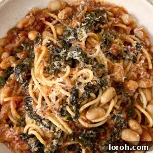 A perfectly plated bowl of Stanley Tucci's Pasta Fagioli, garnished and ready to be enjoyed.