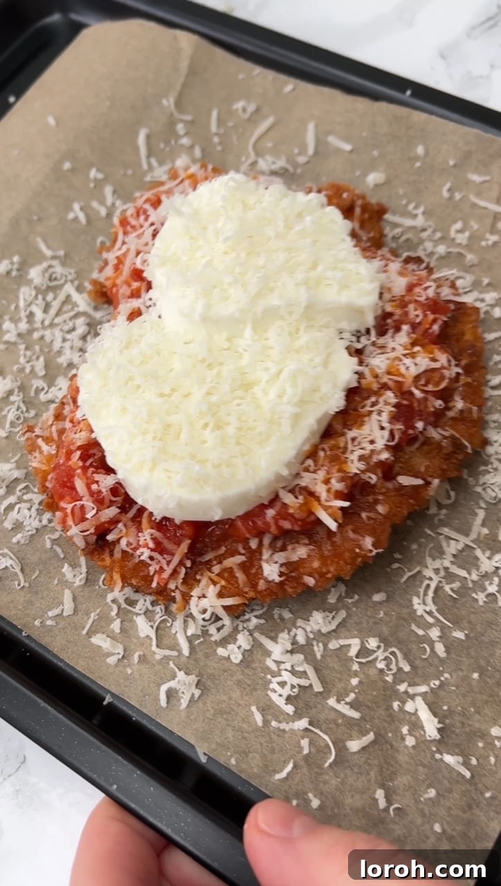 Crispy Chicken Parm Hero 11 Chicken cutlet topped with sauce, mozzarella, and parmesan before grilling