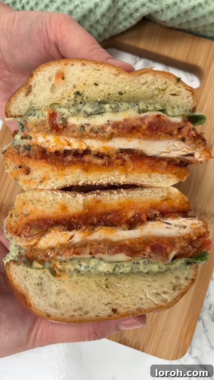 Crispy Chicken Parm Hero 12 Assembling a chicken parmesan sandwich with pesto mayo and basil