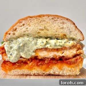 chicken parm sandwich cross section on a marble counter