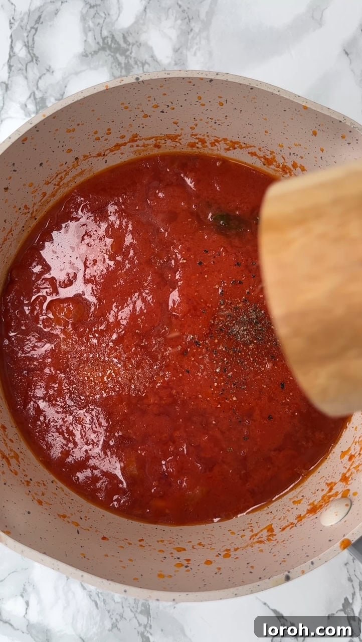 Crispy Chicken Parm Hero 4 Simmering tomato sauce with basil stalks