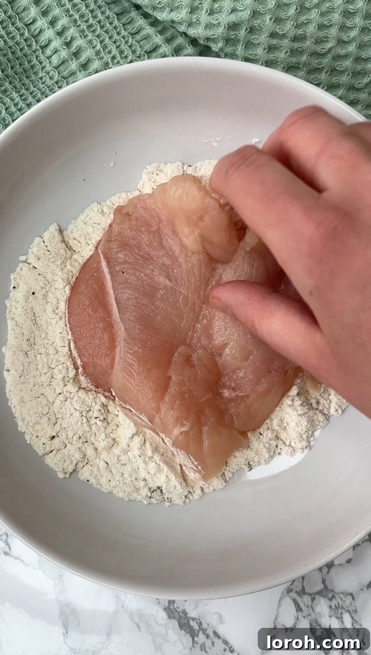Crispy Chicken Parm Hero 7 Flouring the chicken breast for breading