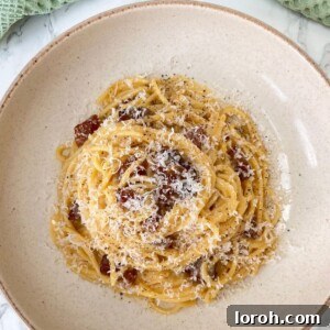 carbonara with guanciale in a beige bowl
