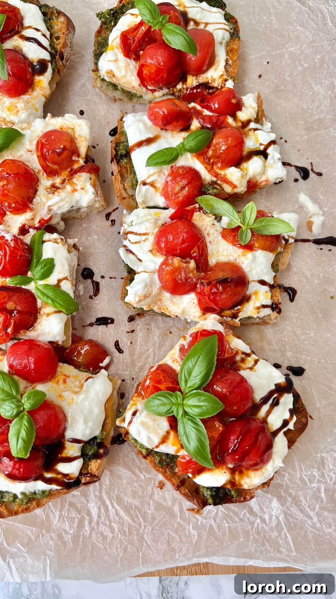 Caprese Bruschetta with balsamic glaze and fresh basil on a rustic serving board, ready to be enjoyed.